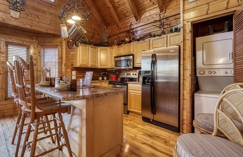 Pigeon Forge Cabin | 1 mile from Pigeon Forge-River frontage-outdoor kitchen-fire pit-Hot Tub-Great Fishing