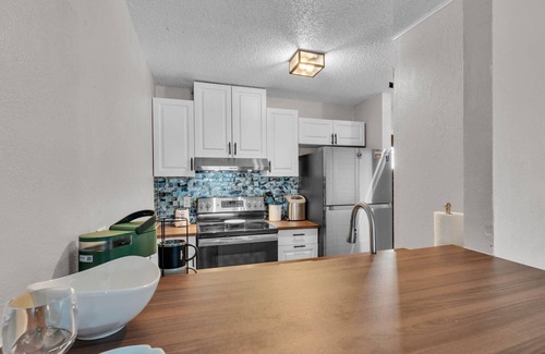 Winter Haven Condo | 2BR Waterfront Condo w/Pool access, Dock, Patio Views & 3 Miles from LEGOLAND