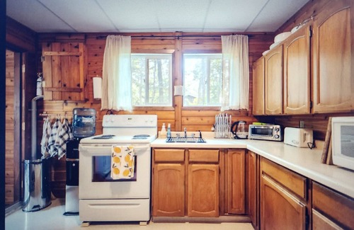 Beaconia House | 3BR Harbor Front House with Fire Pit Canoe, Hammock & Bikes near Grand Beach.