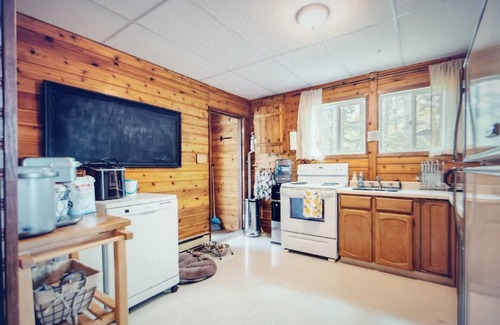 Beaconia House | 3BR Harbor Front House with Fire Pit Canoe, Hammock & Bikes near Grand Beach.