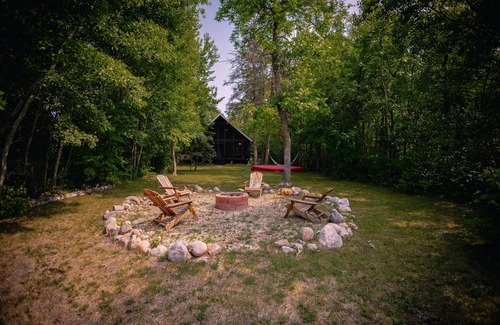 Beaconia House | 3BR Harbor Front House with Fire Pit Canoe, Hammock & Bikes near Grand Beach.
