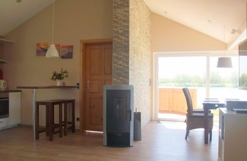 Norderteil House | 4 person vacation home with wood-burning stove, conservatory and canoe, with a wonderful view of the lake in Otterndorf