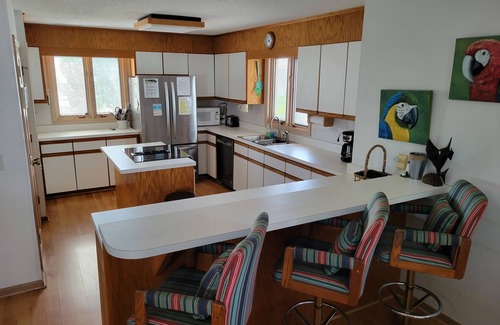 Ocean Isle Beach House | 4bd Canal Front home with an Elevator, dock, fenced back yard, 2 master suites