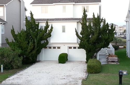 Ocean Isle Beach House | 4bd Canal Front home with an Elevator, dock, fenced back yard, 2 master suites