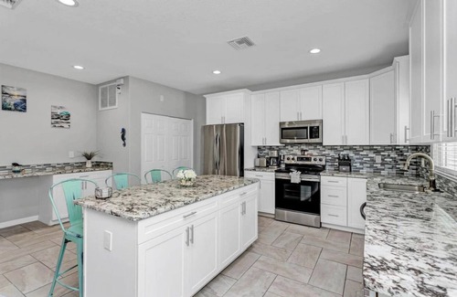 Port Canaveral House | 5 BR beach House, heated salt water pool, hot tub, King bed, & walk to the beach