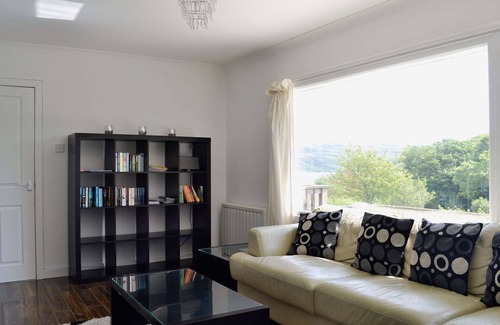 Tighnabruaich Cottage | A detached wooden bungalow, on an open elevated position facing east out to the Kyles of Bute.