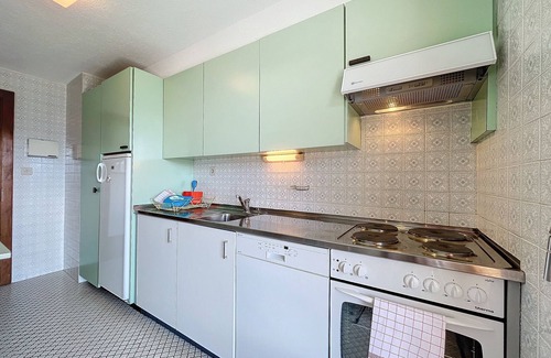 Verbier Apartment | A large entrance hall, living room with dining area and fireplace, kitchen with dishwasher, oven and