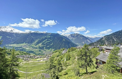 Verbier Apartment | A large entrance hall, living room with dining area and fireplace, kitchen with dishwasher, oven and