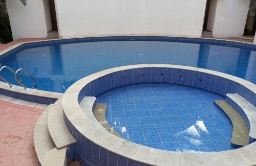 Bengaluru House | Amazistay offers Luxury room with private bathroom, balcony & 55 inch TV & shared Jacuzzi paid access, Book Lover, near Ramaiah College Hospital