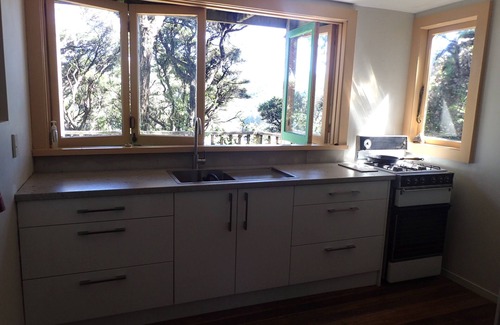 Tryphena House | Bach in quiet bush setting with sea views