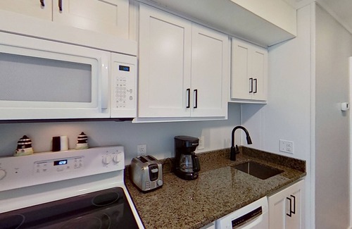 Morehead City Condo | Beachfront home with ocean-view balcony, two pools, waterslide, & beach access