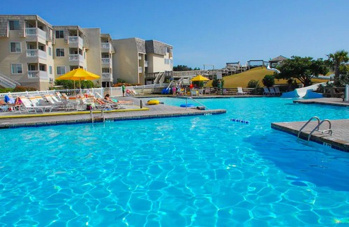Morehead City Condo | Beachfront home with ocean-view balcony, two pools, waterslide, & beach access