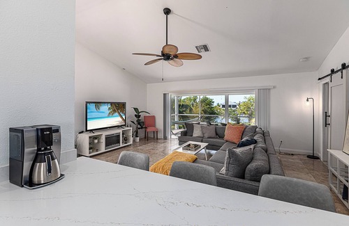 Mid Island House | Beachside Retreat: 2BD/2.5BA + Jet Ski Lifts + Epic Game Room & SHARED Pool!