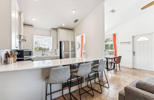 Mid Island House | Beachside Retreat: 2BD/2.5BA + Jet Ski Lifts + Epic Game Room & SHARED Pool!