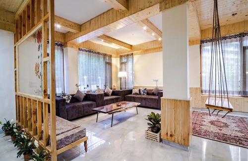 Manali Ski Chalet | Bedroom in a stone and wood chalet admist apple garden