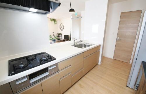 Ojima Island Apartment | blue sea and house