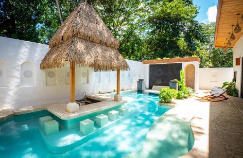 Potrero House | Bohemian Tropical Villa with a Tiki-Style Swimming Pool & Swim-Up Bar with an Attached Studio Apartment