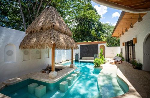 Potrero House | Bohemian Tropical Villa with a Tiki-Style Swimming Pool & Swim-Up Bar with an Attached Studio Apartment