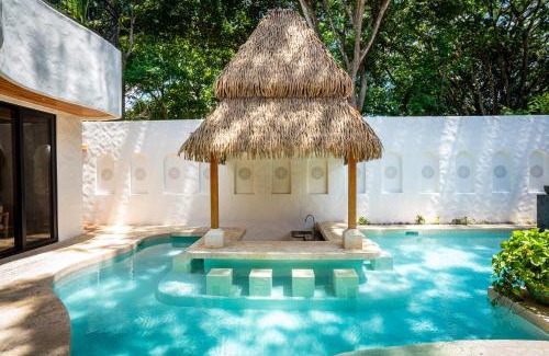 Potrero House | Bohemian Tropical Villa with a Tiki-Style Swimming Pool & Swim-Up Bar with an Attached Studio Apartment