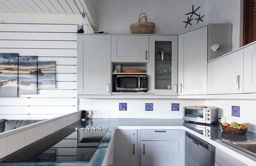 Estate Enighed Condo | Bright and welcoming corner condo with a lovely wrap-around deck—ideal for soaking in those beautiful sunsets!