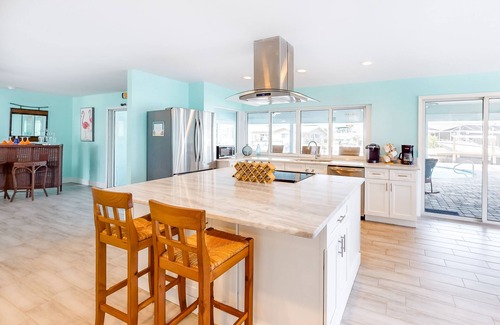 Lochmoor Waterway Estates House | Canal-front home with heated saltwater pool, dock, grill, & covered patio