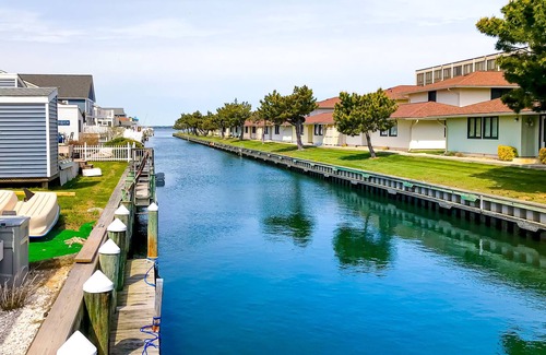 North Ocean City House | Canal-front home with private dock, deck, grill, central AC, and free WiFi