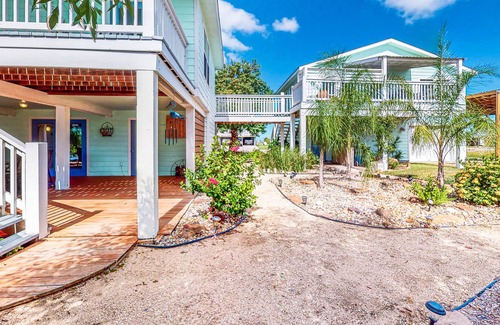 Rockport House | Canal-front retreat with dock/bay access, hot tub, covered deck, kayaks, & AC