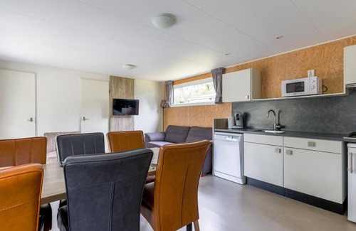 Vessem Ski Chalet | chalet with covered terrace on campsite with pool