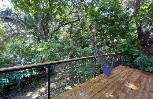 Buenos Aires Ski Chalet | Chalet with jungle view deck on a river in lively Santa Teresa's surf town