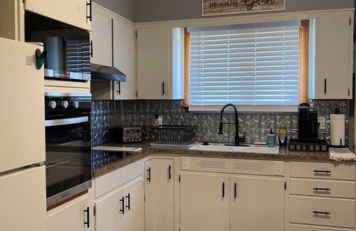 Atchison House | Charming 2-bedroom house in Atchison on quiet brick and tree lined street.