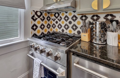Inman Park Apartment | Charming 2BR/2BA lower-level unit in a classic Inman Park duplex. Features full kitchen, cozy living area with fireplace, Southern-style front porch, clawfoot tub, in-unit laundry, and dedicated parking. Walkable to dining and MARTA.