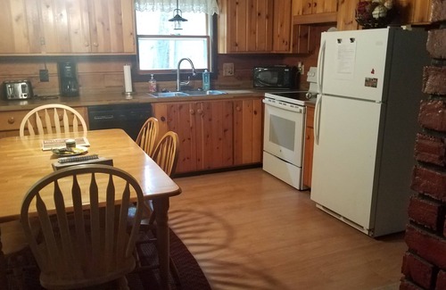 Rowleys Bay House | Charming cedar log cabin nestled in the woods, footsteps from Rowley's Bay