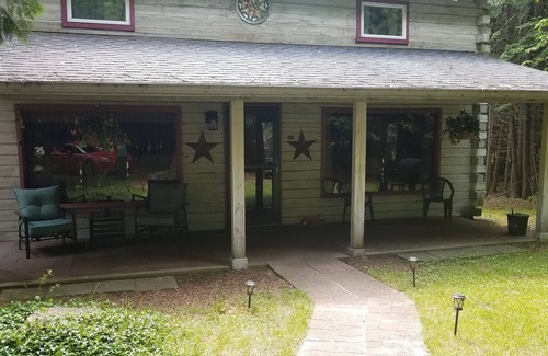 Rowleys Bay House | Charming cedar log cabin nestled in the woods, footsteps from Rowley's Bay