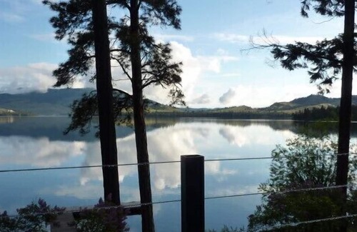 Big Arm House | Charming Lake Front Home with Deck, Dock, Beach and Spectacular Views