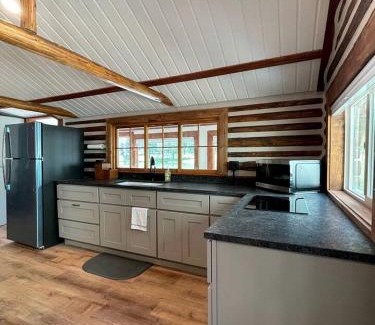 Island Park House | Charming Riverfront Cabin with Hot Tub and Dock Access Near Scenic Trails in Island Park, Idaho