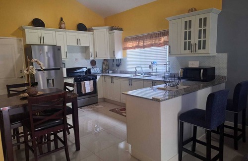 Spanish Town House | Charming sanctuary in the picturesque Caymanas Estates area.