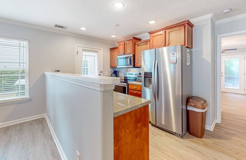 Savannah House | Charming townhome with tree-lined deck, pool and dock access, & updated interior
