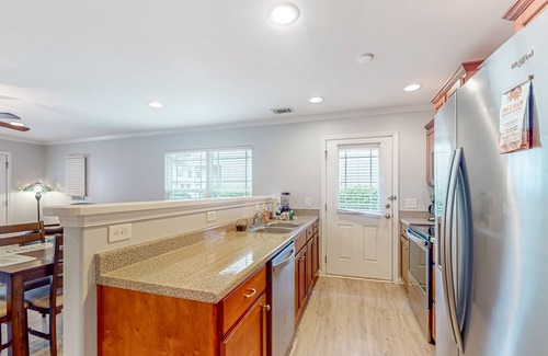 Savannah House | Charming townhome with tree-lined deck, pool and dock access, & updated interior