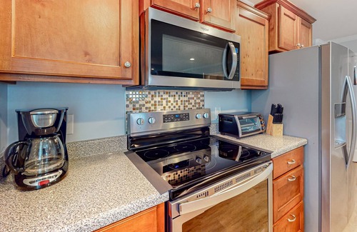 Savannah House | Charming townhome with tree-lined deck, pool and dock access, & updated interior