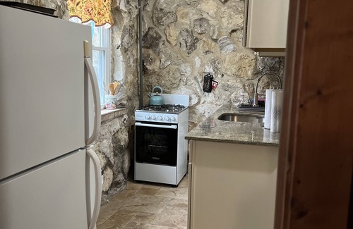 Hernando Cottage | Cheerful water front stone cottage. With beach. on bike trail.