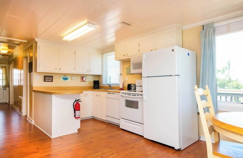 Kitty Hawk House | Classic, semi ocean front OBX cottage steps away from the beach.
