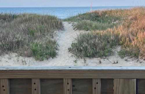 Kitty Hawk House | Classic, semi ocean front OBX cottage steps away from the beach.
