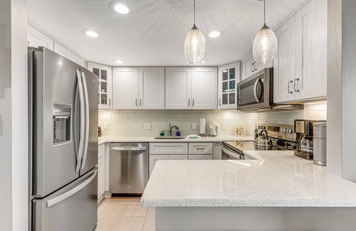 North Ocean City House | Coastal-themed beachfront condo with balcony views, pools, game room & gym