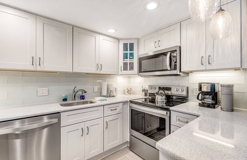 North Ocean City House | Coastal-themed beachfront condo with balcony views, pools, game room & gym