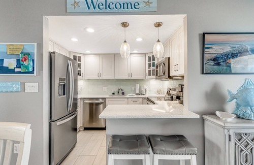 North Ocean City House | Coastal-themed beachfront condo with balcony views, pools, game room & gym