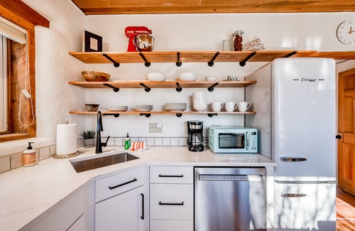 Taos House | Colorful dog-friendly home with sweeping views, a private hot tub, & large yard
