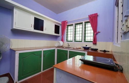 Devikolam House | Colorful Facade with greenery Nest Stay