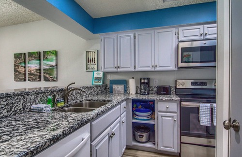 New Braunfels Condo | COMAL RIVERFRONT! Across from Schlitterbahn! Walk to Downtown New Braunfels!