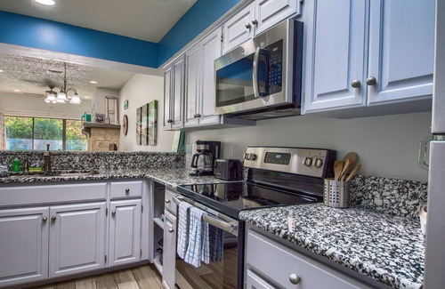 New Braunfels Condo | COMAL RIVERFRONT! Across from Schlitterbahn! Walk to Downtown New Braunfels!