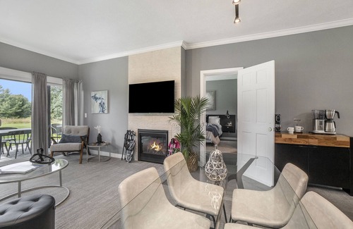 Cedar Condo | Come cozy up next to the fireplace at our contemporary condo centrally located